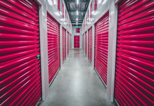 Business storage units with red shutter doors. 